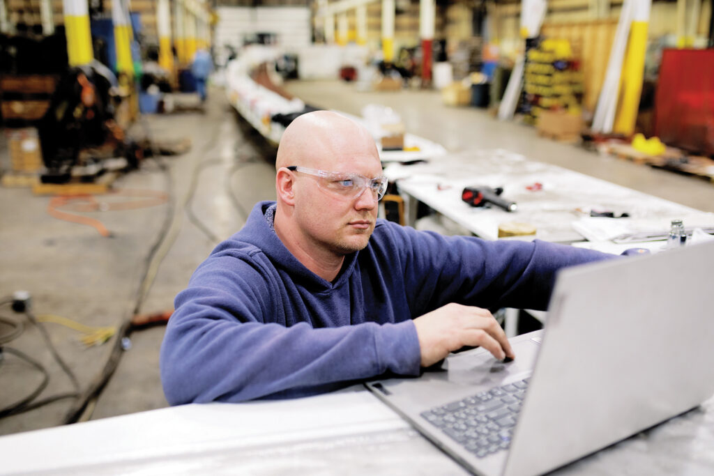 Man using a laptop in a workshop
