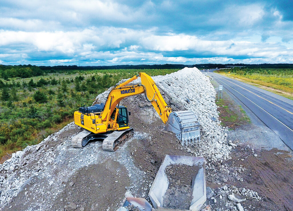 Sustainable construction practices: Komatsu PC360LC Excavator recycling and reusing materials highlighting sustainable construction practices