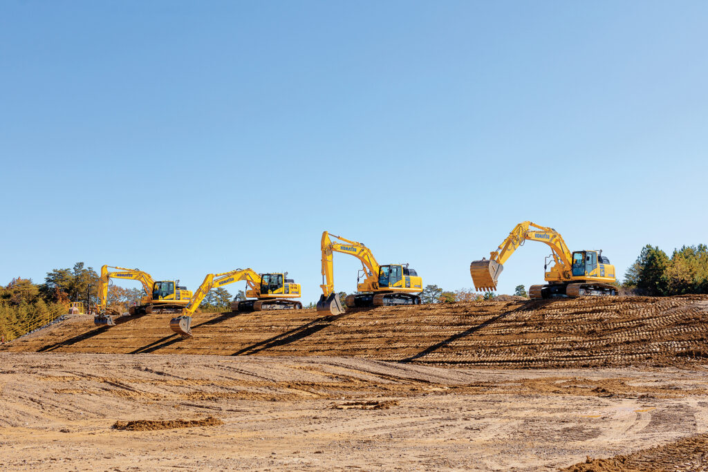 Komatsu’s iMC 2.0 excavators, including the recently introduced PC290LCi-11, PC360LCi-11 and PC390LCi-11, lined up on a hill