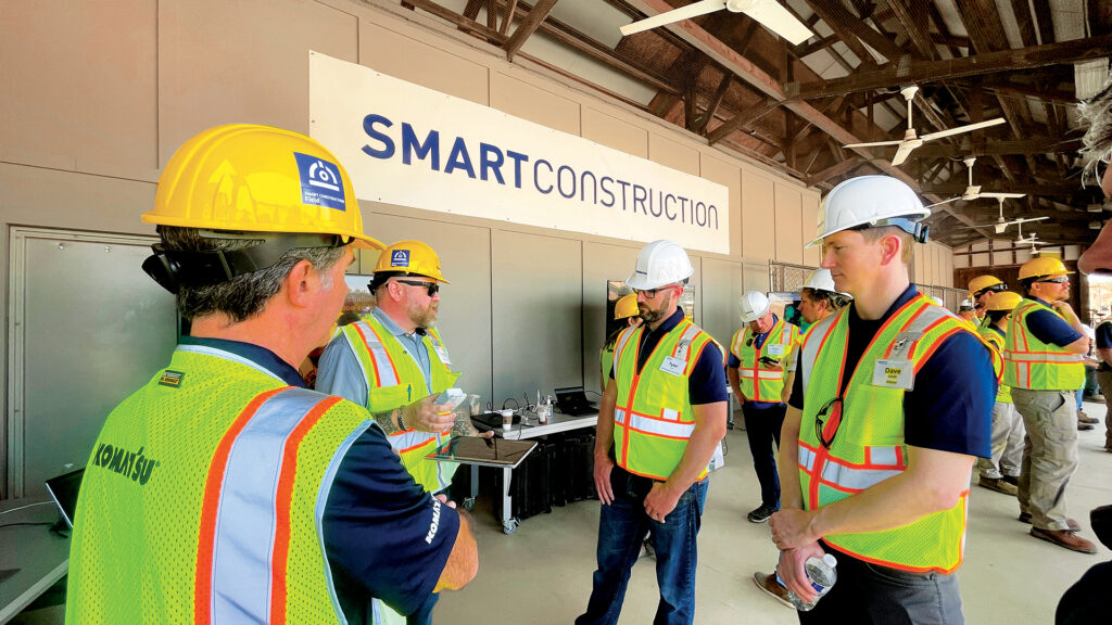 Smart Construction personnel at Komatsu Demo Days 2022 answering questions about how the solutions can transform attendees’ businesses and make them more efficient.