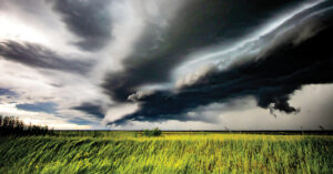 extreme weather events | Pictured: A storm and cloudy, dark skies over green grass