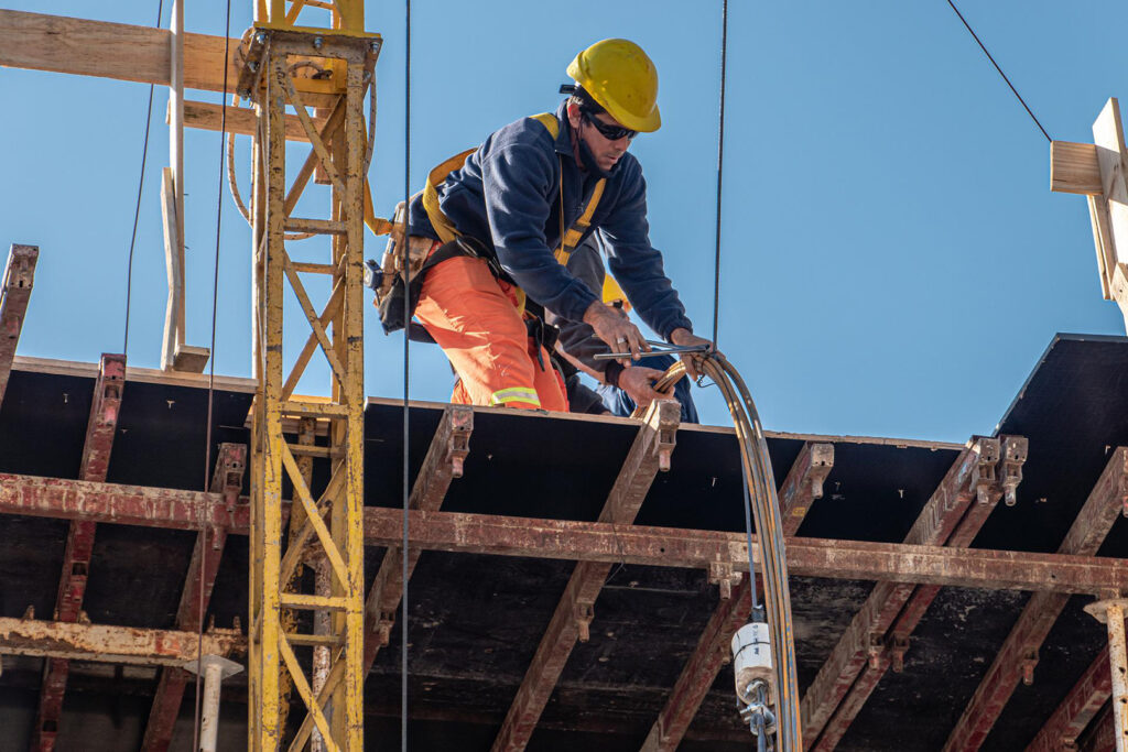 A construction worker working on an elevated platform