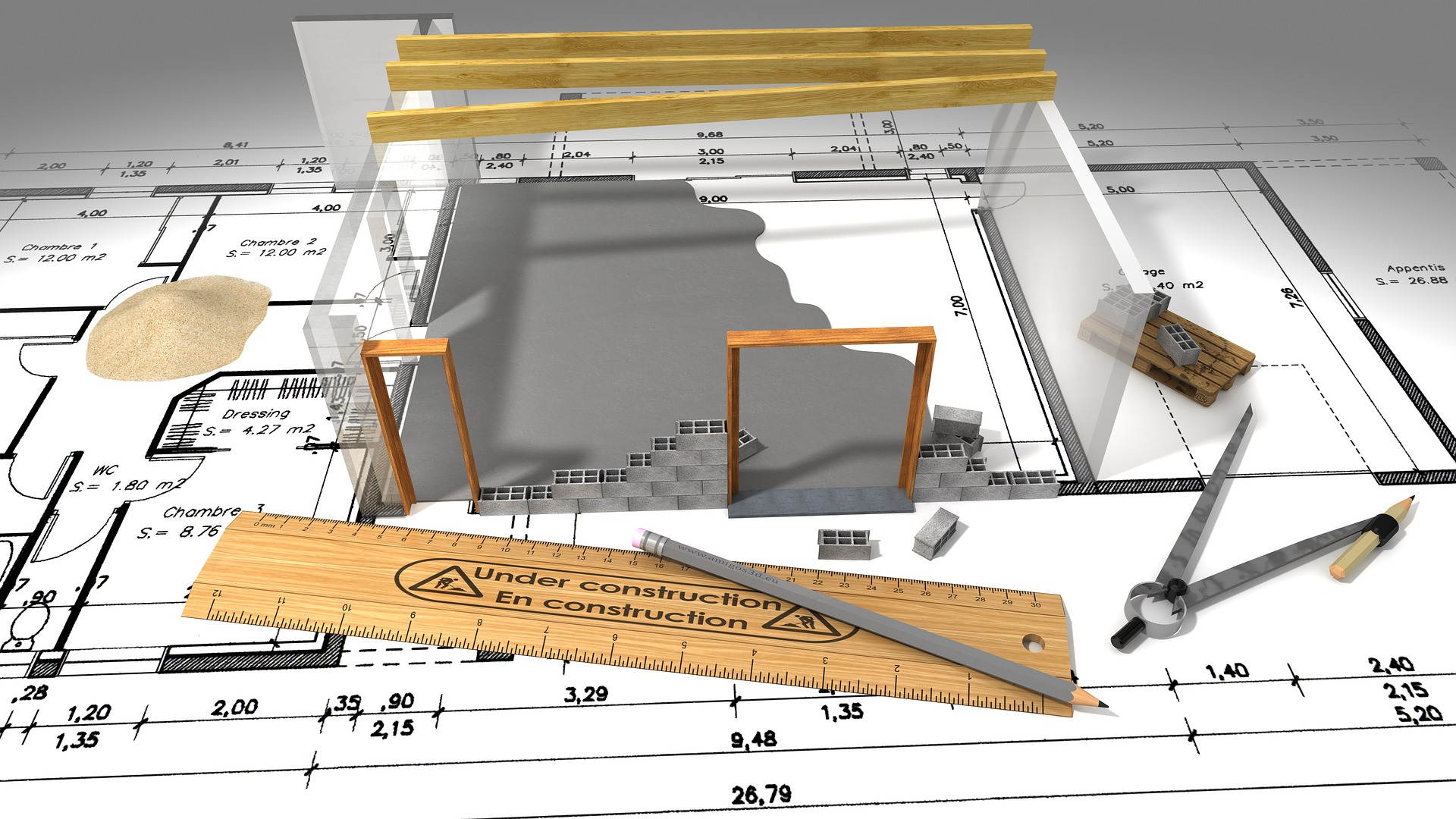 A 3D model of a building and a ruler sit on top of paper building plans