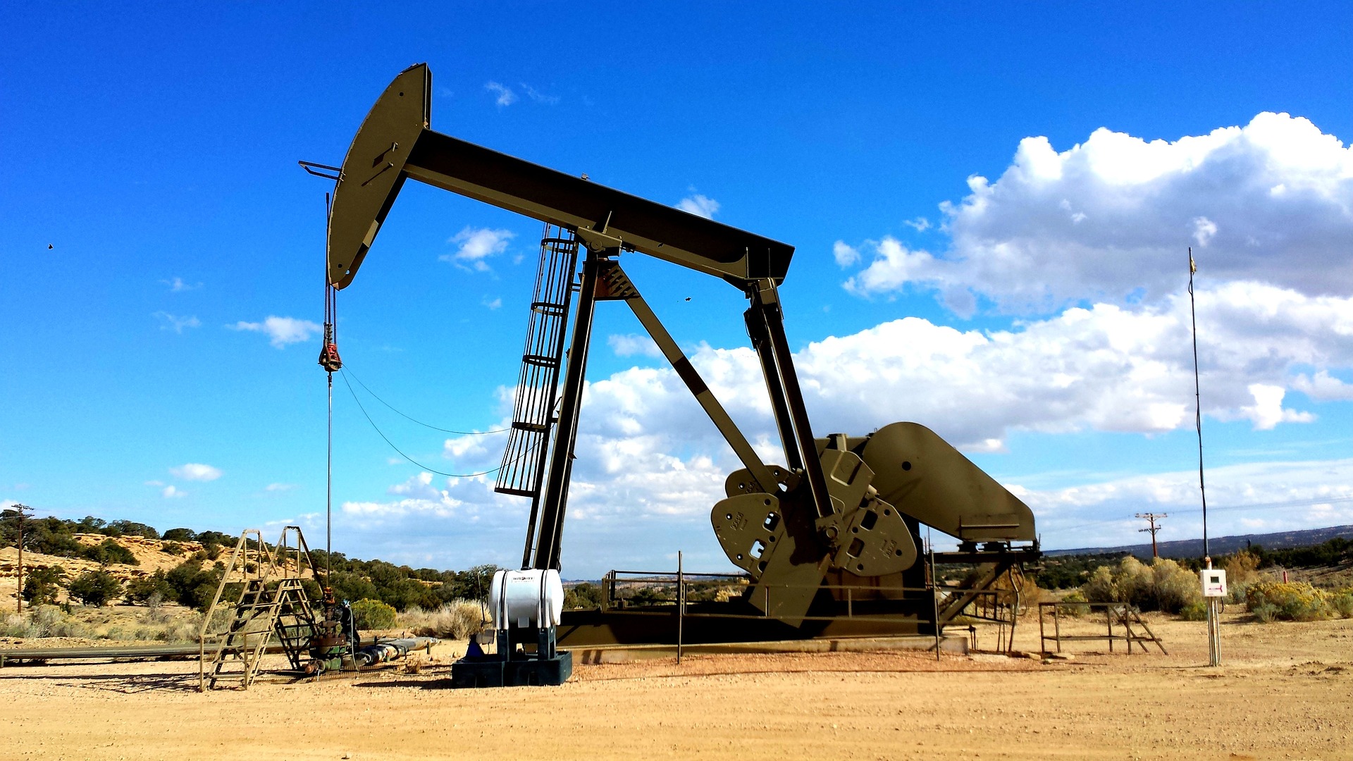An oil pump standing in a flat desert