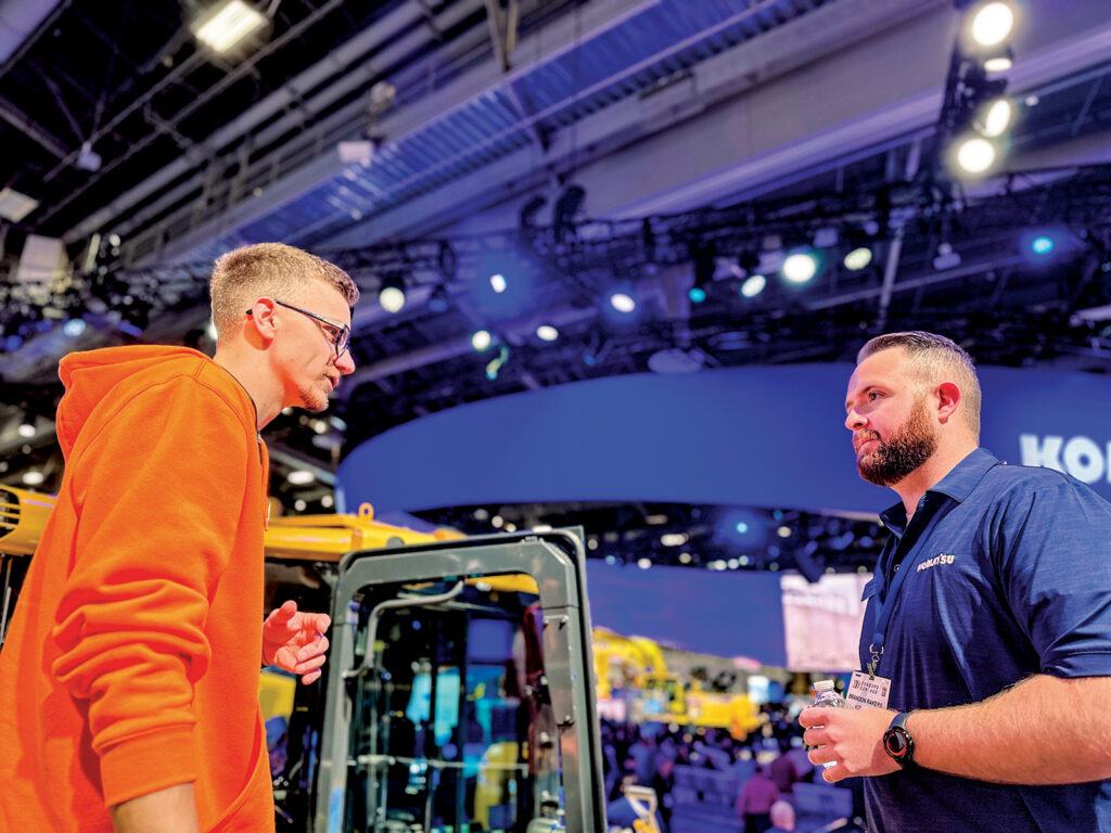Komatsu’s Brandon Rakers, Senior Product Manager for Technology Business Solutions, answering a CONEXPO attendee's questions about equipment and technology