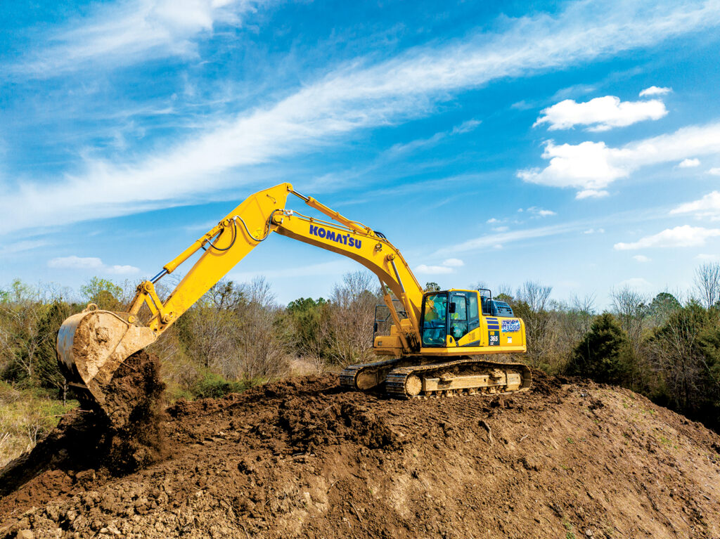 An image of an operator unloading material with a Komatsu HB365LC-3 hybrid excavator