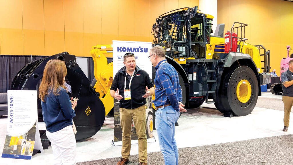 An image of NDA expo attendees interacting in front of a Komatsu WA475-10 WH wheel loader