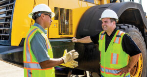 Two Construction Workers talking in front of Komatsu WA470 Wheel Loader