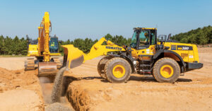 A Komatsu Excavator works with a Komatsu WA380 Wheel Loader