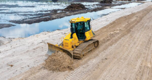 A Tomahawk Construction operator cuts a road with a Komatsu D51PXi-24 iMC dozer.