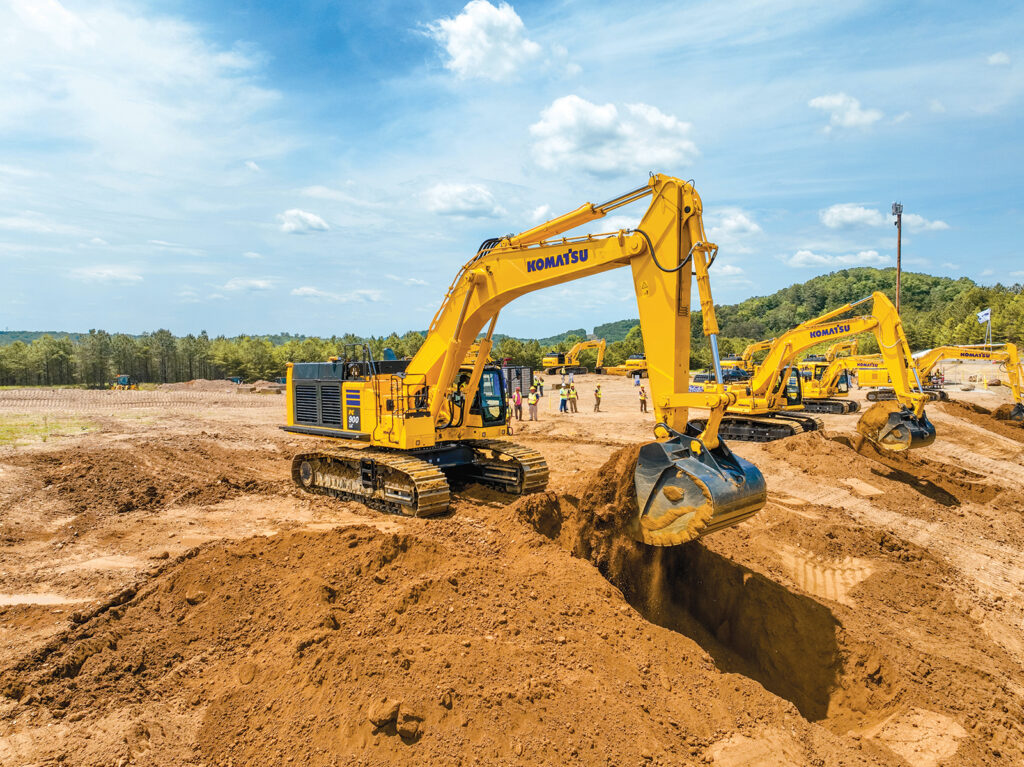At Demo Days, an attendee scoops material with a Komatsu PC900LC-11 excavator.