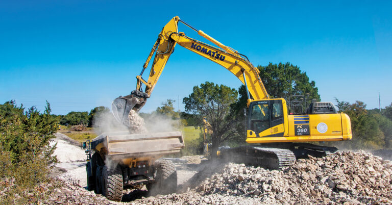 IMC equipment | Two Komatsu machines, a PC360-LCi and a truck, both owned by Gage & Cade Construction LLC move rocks.