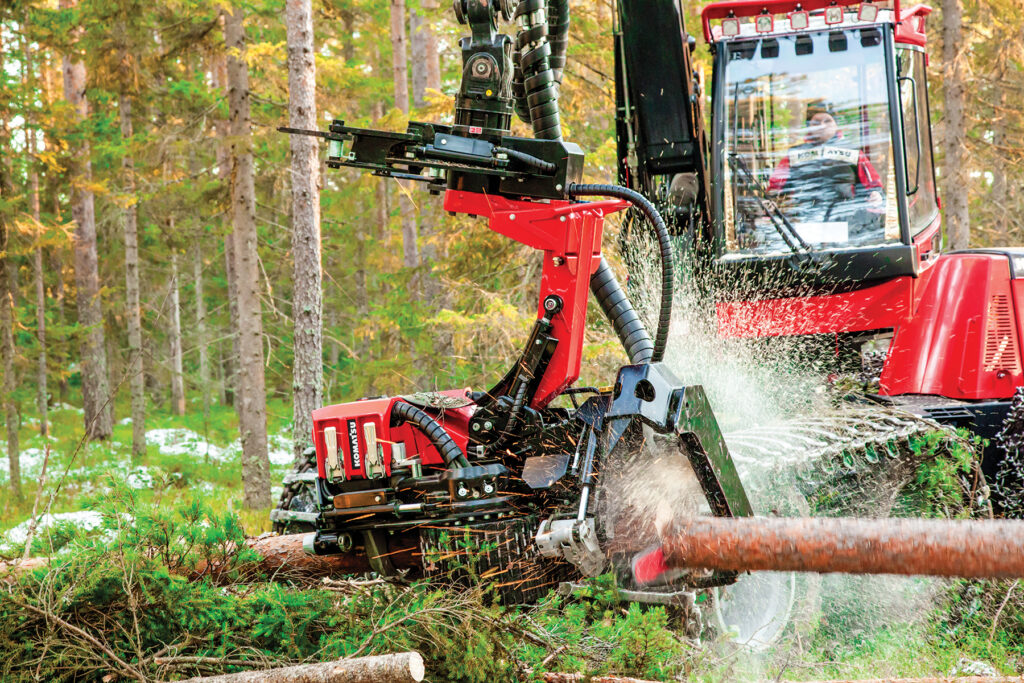 Komatsu’s S92 harvester head cutting trees in a forest setting