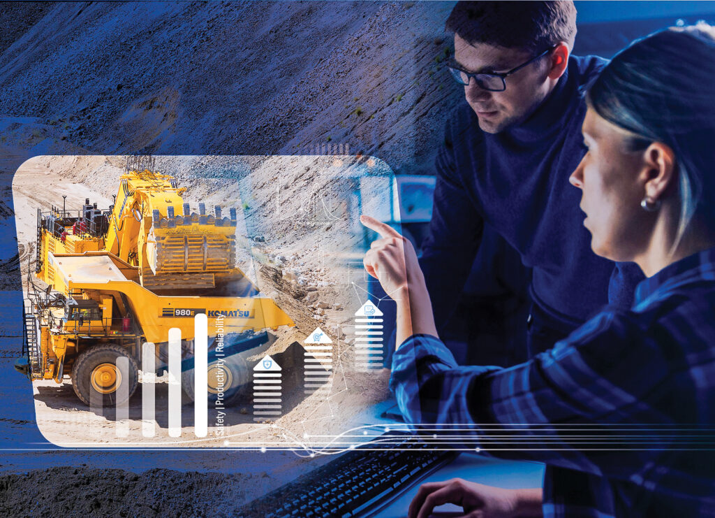 a man and a woman point at an overlayed image of charts and images of Komatsu machines