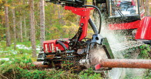 Komatsu’s S92 harvester head cutting wood in a forested area