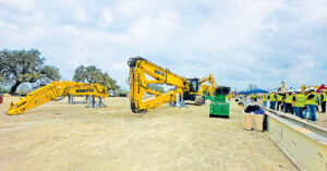 A crowd gathered in front of Komatsu’s new PC490HRD-11 high-reach demolition excavator, observing the machine at the NDA demolition show.