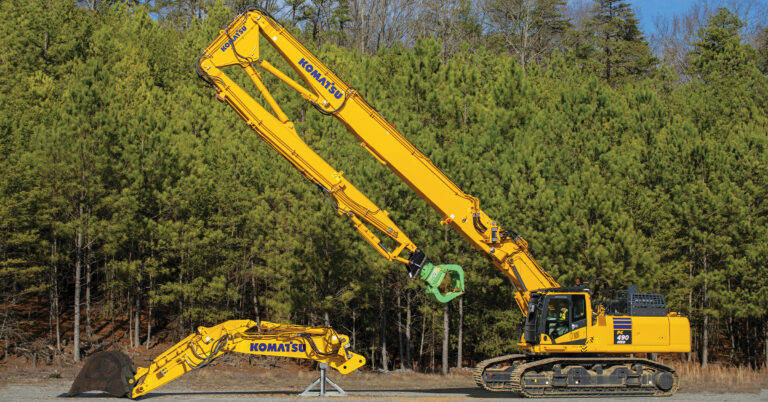 An image of a Komatsu PC490HRD-11 excavator with an optional reconfiguration shown in front of it.